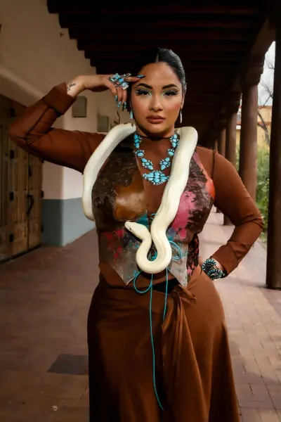 Model in brown outfit with a white snake