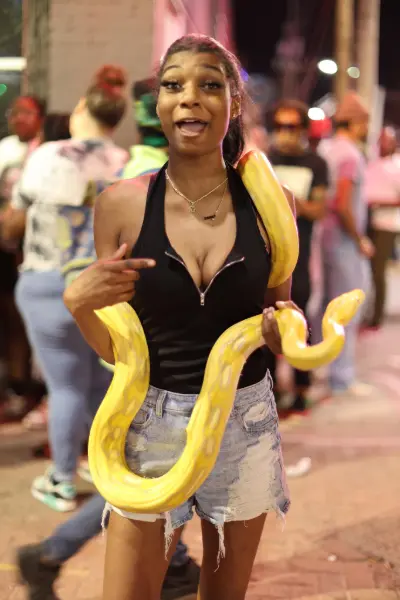Woman holding a large yellow albino python in Tulsa