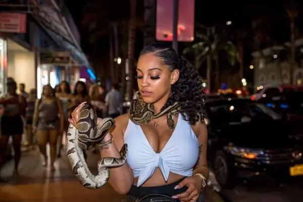 Woman holding a snake at a night street encounter in San Diego