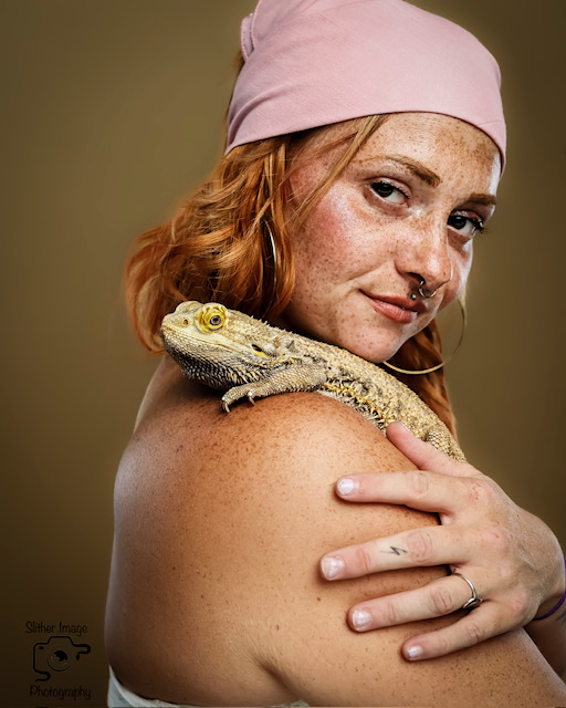 Model posing with a bearded dragon