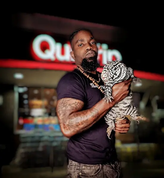 Solofa Halley holding a snake outdoors