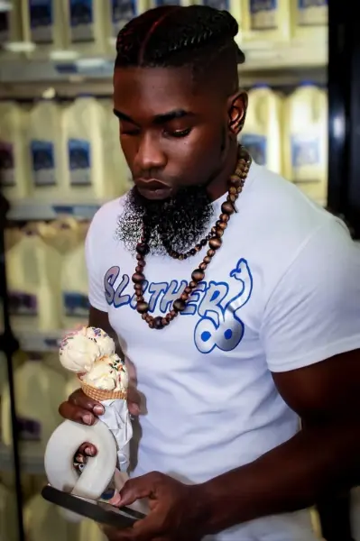 Solofa Halley interacting with the public with a snake