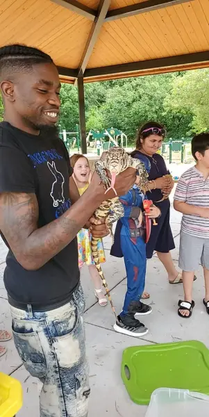 Solofa Halley with a large snake during an event